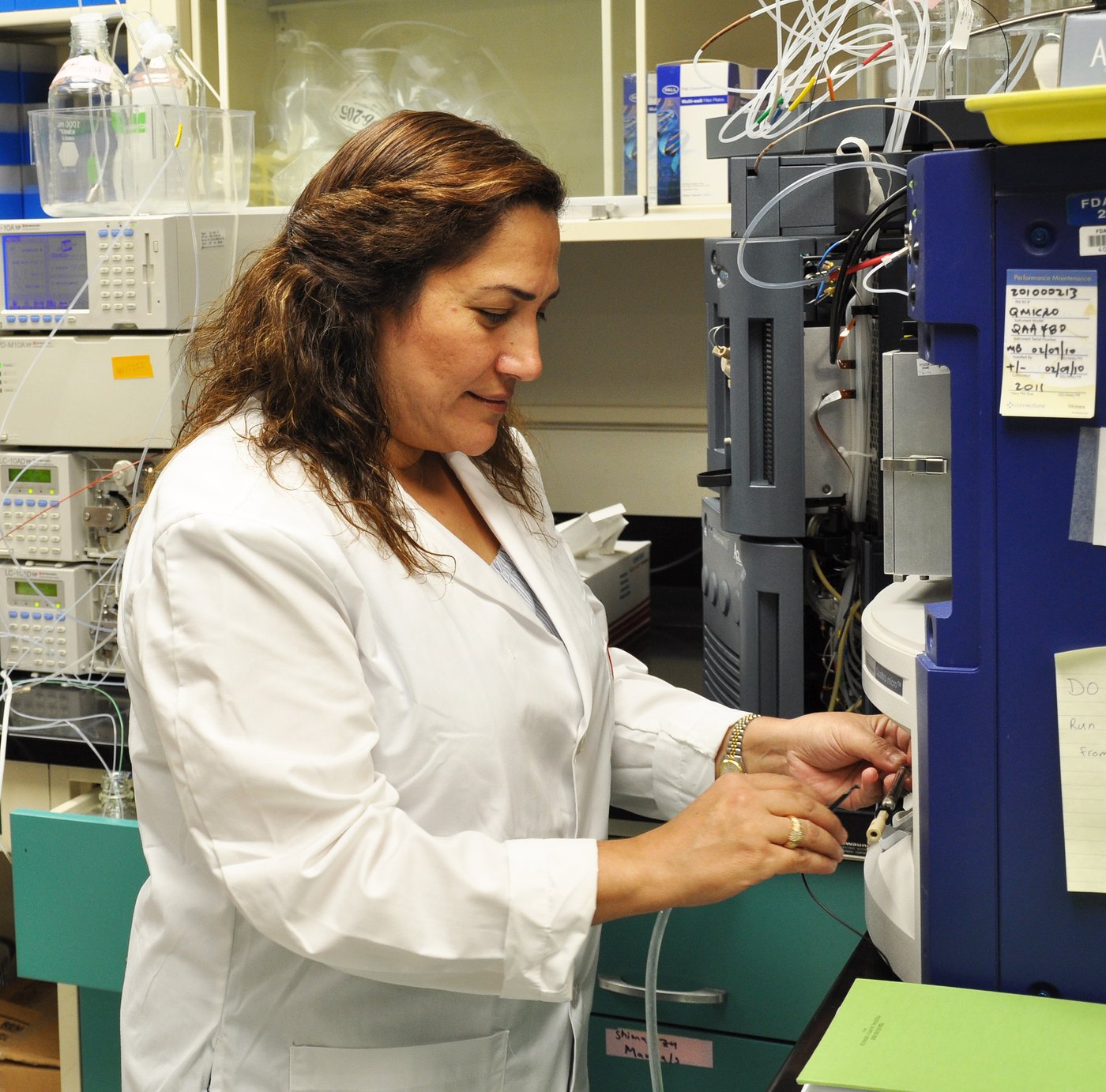 A scientist loading a sample into an HPLC-MS/MS instrument for precise quantitative analysis (U.S. FDA/NCTR) — the measurement discipline behind the QuantMedi dosage calculator by Panacea Bio Chem and Bogdan Dicoias